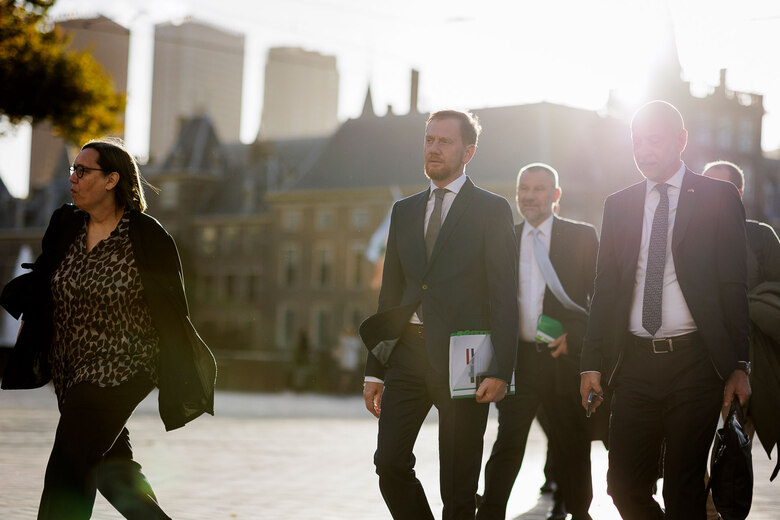 Mehrere Menschen laufen im Sonnenaufgang.